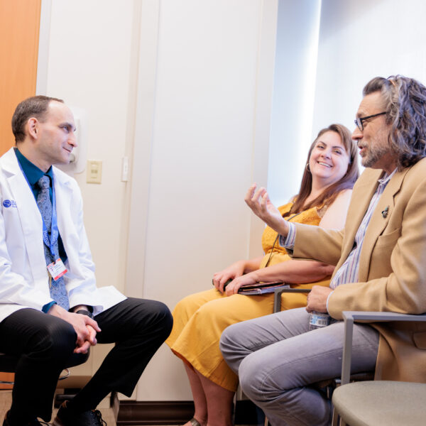 Dr. Vladimir Shvarts interacting with patient Randy Ehlers and the patient's friend in the clinic.