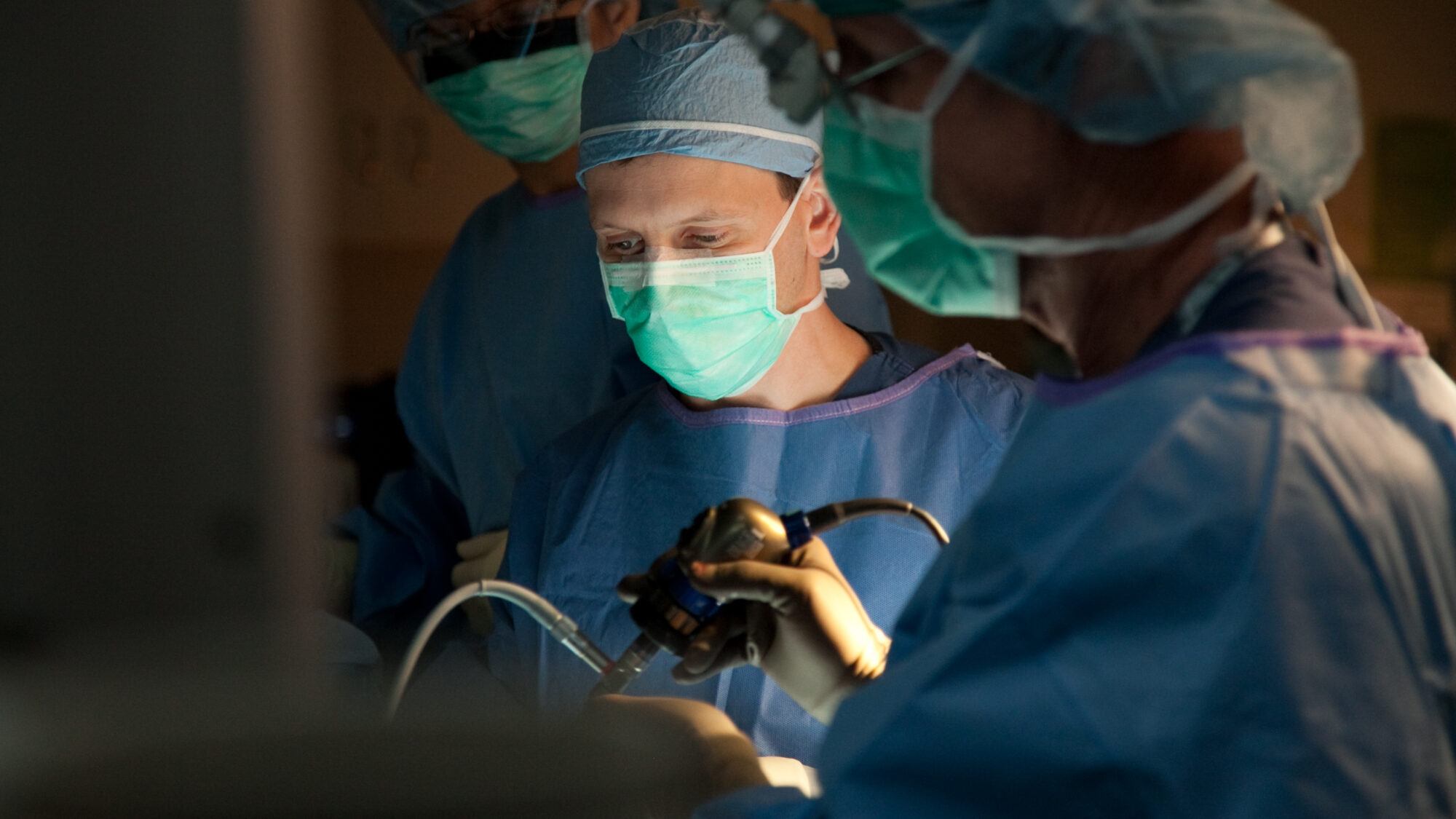 pituitary surgeon andrew little performs surgery in an operating room