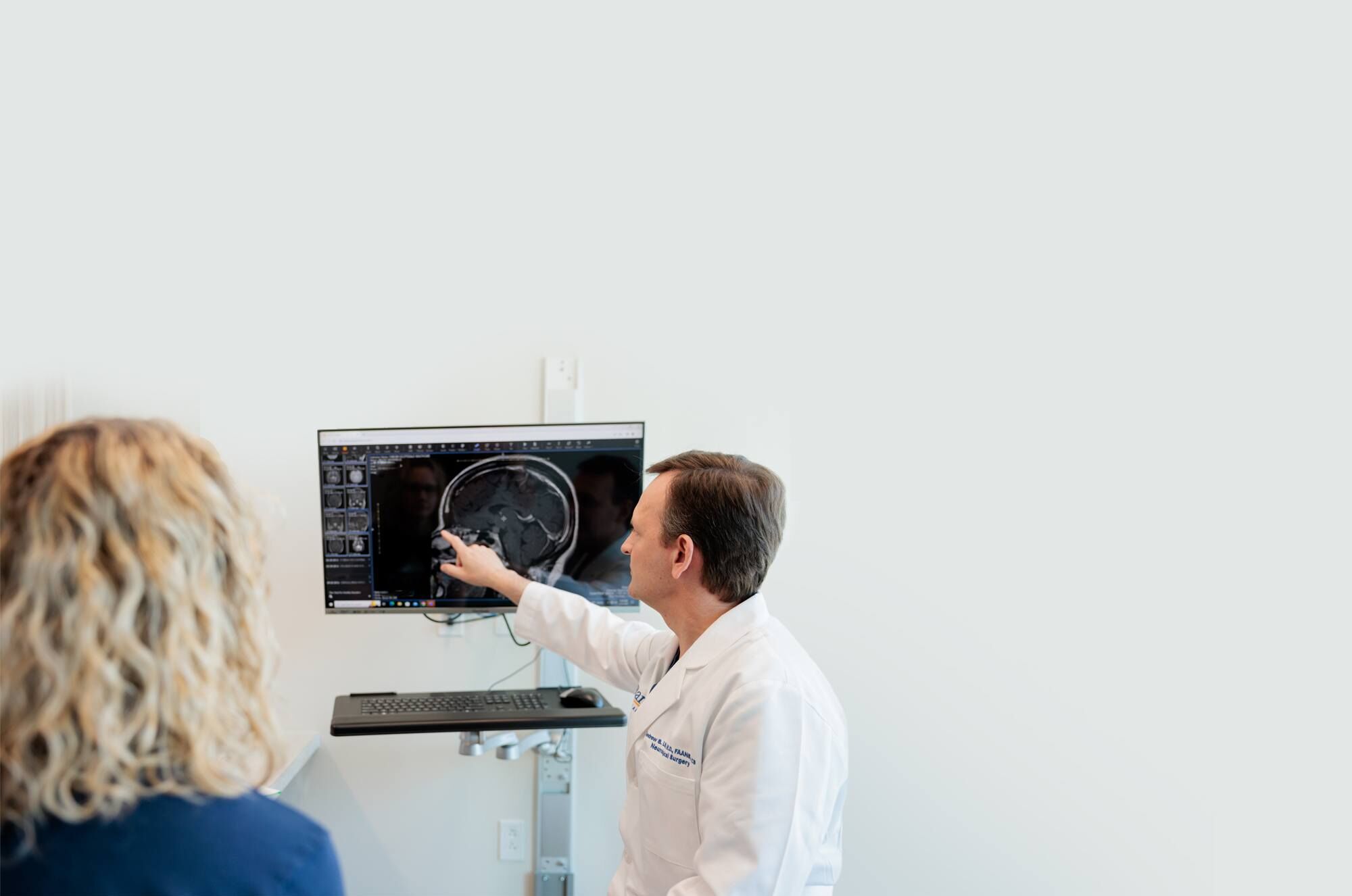 pituitary neurosurgeon andrew little discusses an mri scan with a patient