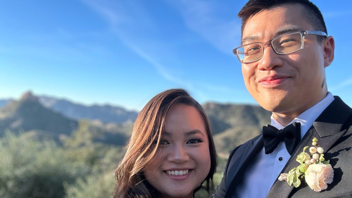 peter mai standing with fiance in front of a desert landscape