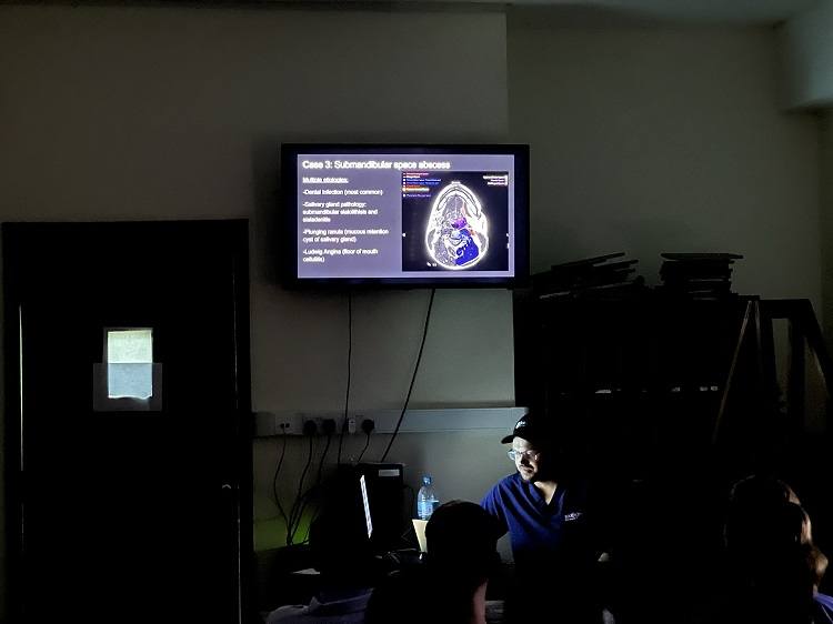 Barrow PGY-7 neuroradiology fellow Dr. Dane Hellwig giving a lecture to KCMC radiologists and visiting students