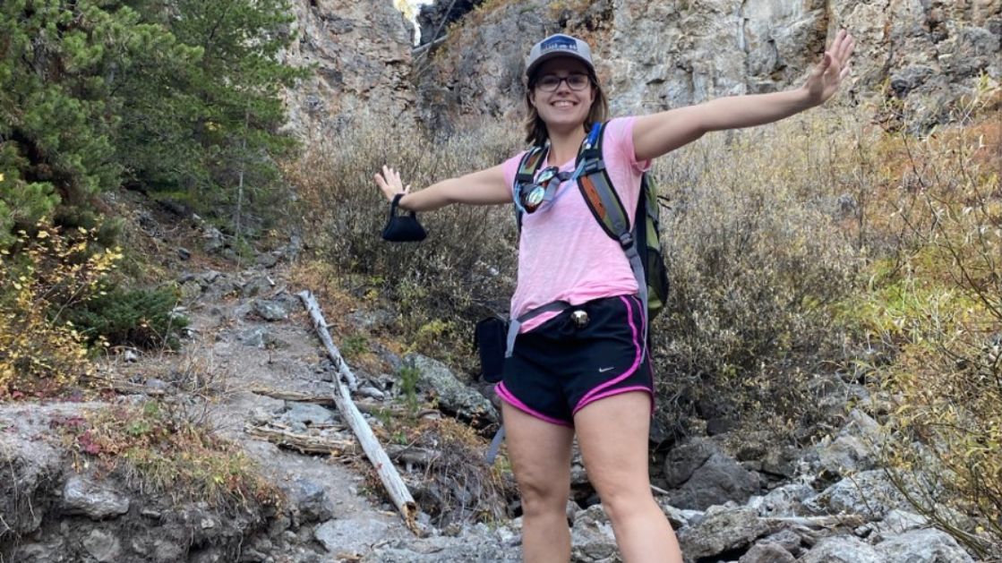 christine stevens on a hike in a canyon with trees