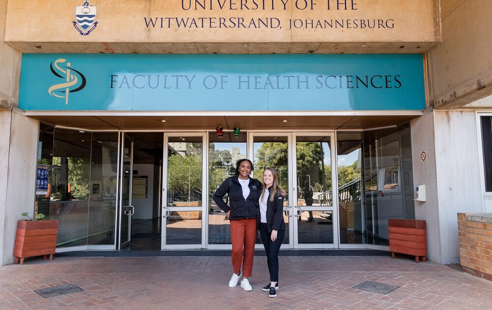 huiam mubarak and alyssa bowlsby standing in front of wits university