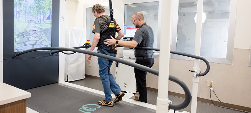 a physical therapist conducts neuro-rehabilitation with a patient